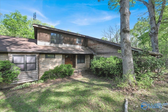 143 Maze Dr, Hartselle, AL 35640 - back of house featuring brick siding and a lawn