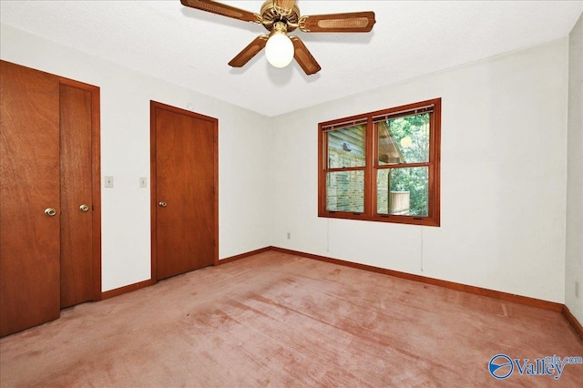 143 Maze Dr, Hartselle, AL 35640 - unfurnished bedroom featuring light carpet, baseboards, and a ceiling fan