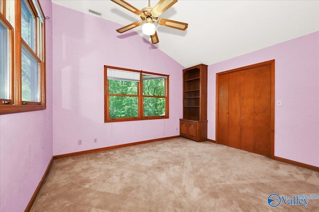 143 Maze Dr, Hartselle, AL 35640 - unfurnished bedroom with carpet floors, vaulted ceiling, baseboards, ceiling fan, and a closet