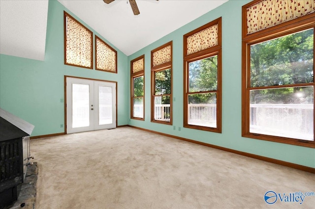 143 Maze Dr, Hartselle, AL 35640 - unfurnished living room featuring french doors, plenty of natural light, carpet, and lofted ceiling