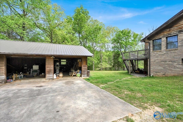 143 Maze Dr, Hartselle, AL 35640 - view of grassy yard featuring stairway, an outdoor structure, a wooden deck, and a garage