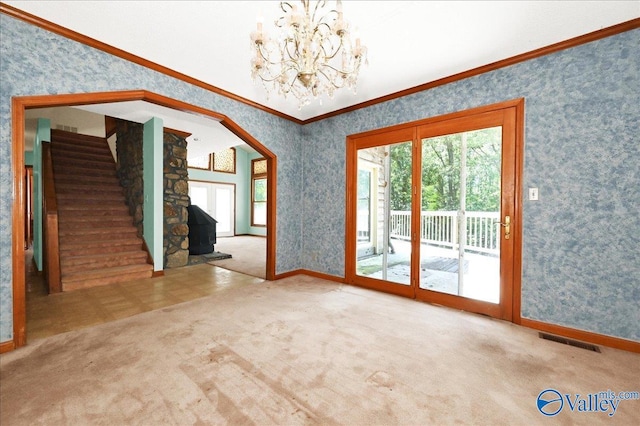 143 Maze Dr, Hartselle, AL 35640 - carpeted empty room with ornamental molding, a chandelier, wallpapered walls, stairs, and baseboards