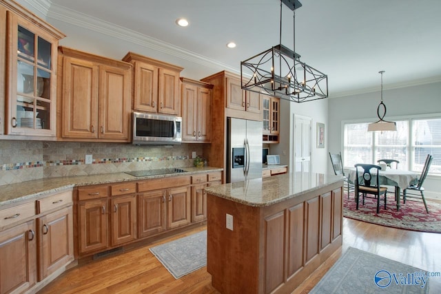 kitchen with light wood finished floors, ornamental molding, stainless steel appliances, and tasteful backsplash