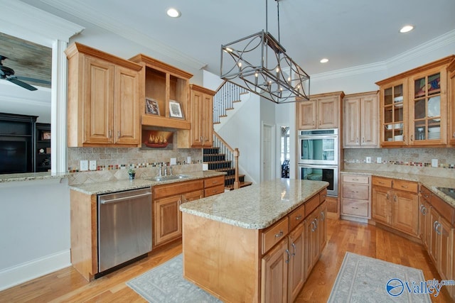 kitchen with stainless steel appliances, glass insert cabinets, light wood-style floors, and ornamental molding