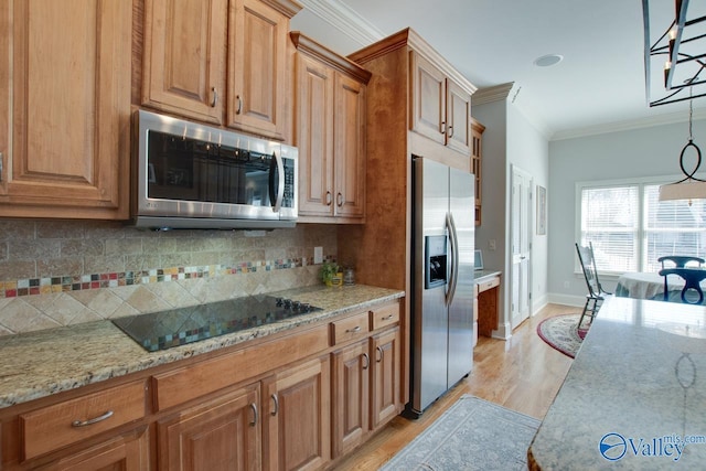 kitchen featuring backsplash, light stone countertops, ornamental molding, light wood-style flooring, and appliances with stainless steel finishes