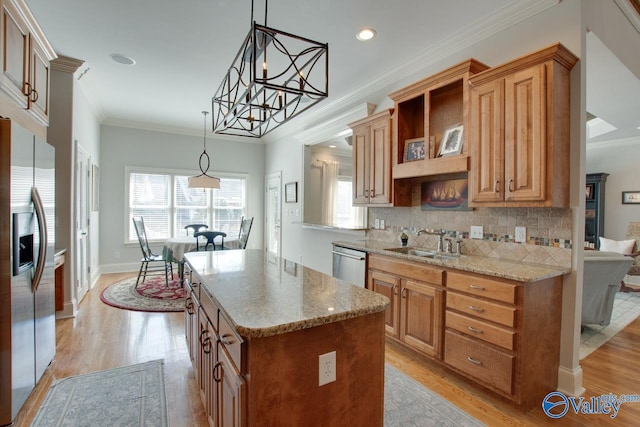 kitchen featuring light wood finished floors, backsplash, light stone counters, stainless steel appliances, and a sink