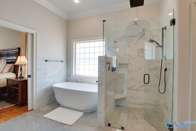 full bath with ornamental molding, wood finished floors, a marble finish shower, tile walls, and a soaking tub