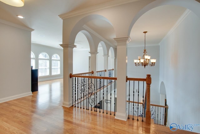 stairs featuring wood finished floors, baseboards, and ornamental molding