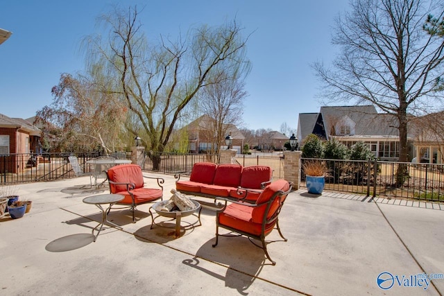 view of patio featuring an outdoor living space with a fire pit and fence