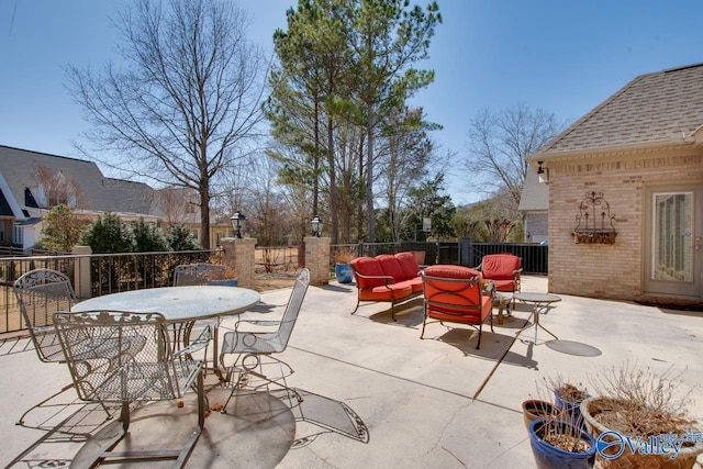 view of patio featuring an outdoor living space, outdoor dining area, and fence