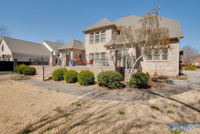 exterior space with brick siding and fence