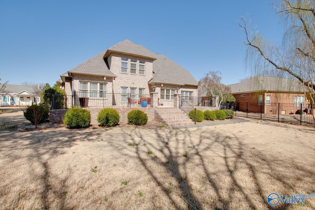 back of house with brick siding and fence