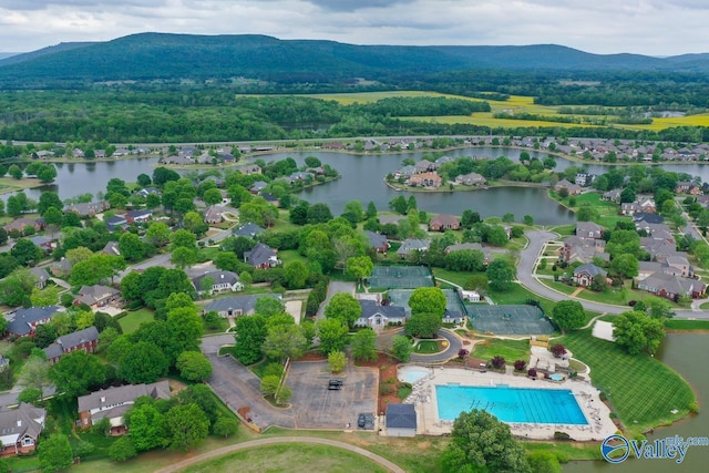 drone / aerial view featuring a water and mountain view