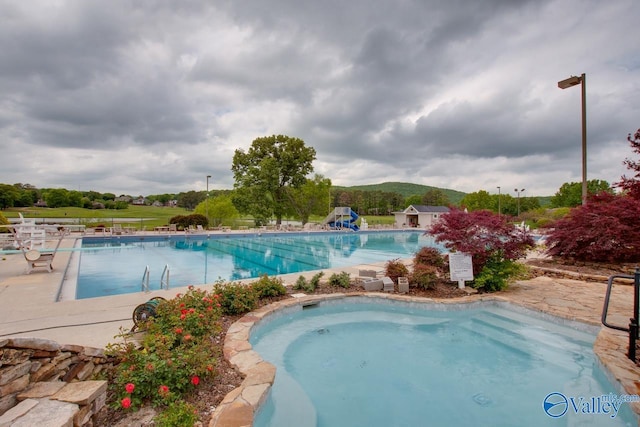 pool featuring a mountain view and a patio