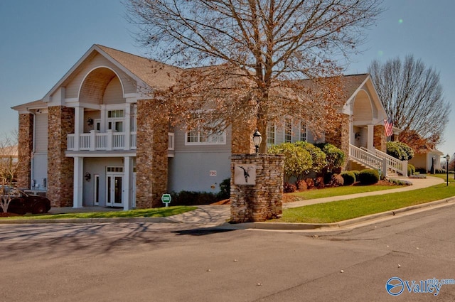 view of front of property with french doors and a balcony