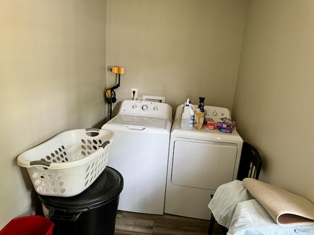 laundry area with independent washer and dryer and dark hardwood / wood-style floors