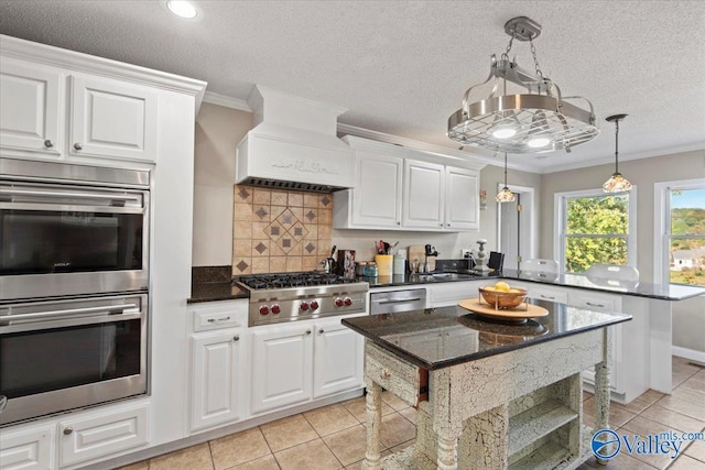 kitchen featuring a breakfast bar area, white cabinetry, backsplash, appliances with stainless steel finishes, and crown molding