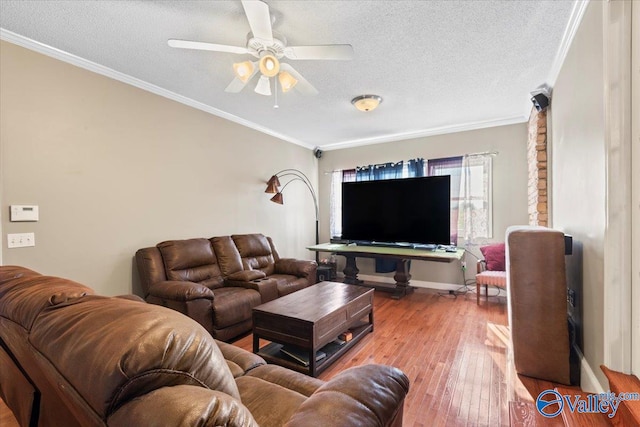 living room featuring ornamental molding, wood-type flooring, and ceiling fan