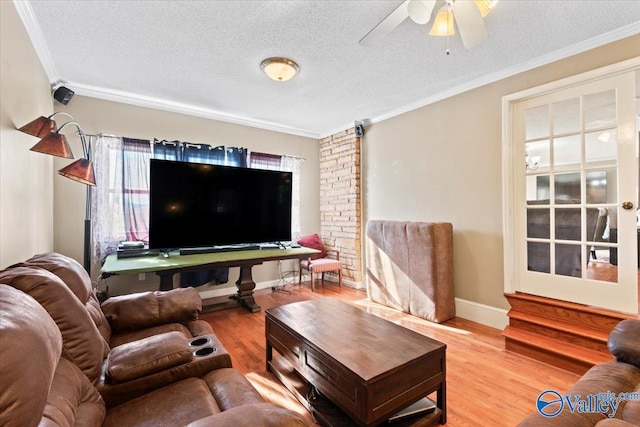 living room with a textured ceiling, crown molding, ceiling fan, and hardwood / wood-style flooring