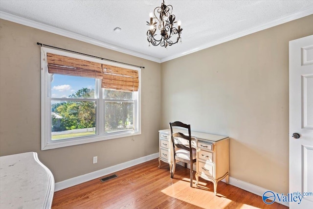 office area featuring light hardwood / wood-style flooring, ornamental molding, a textured ceiling, and a notable chandelier