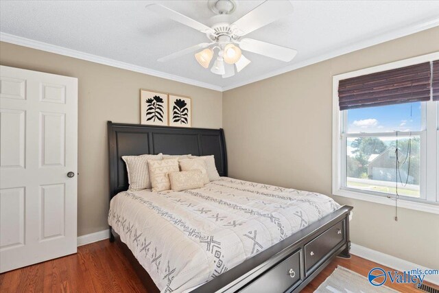 bedroom featuring ornamental molding, ceiling fan, and dark hardwood / wood-style flooring