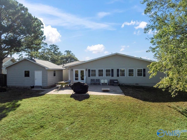 back of house featuring a lawn and a patio area