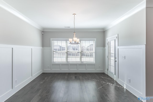 unfurnished dining area with a chandelier, dark hardwood / wood-style floors, and crown molding