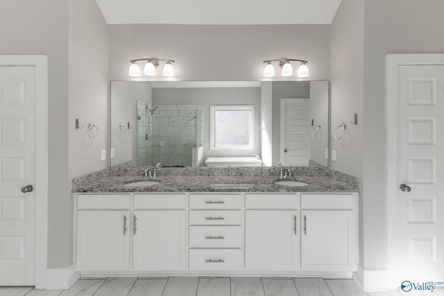 bathroom with vanity and a shower with shower door