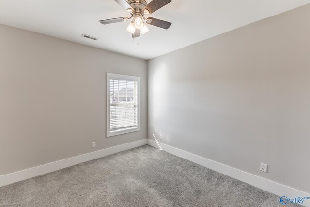 carpeted spare room featuring ceiling fan