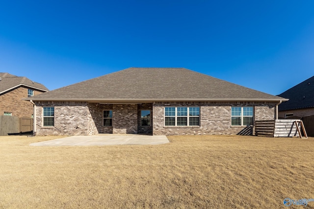 back of property featuring a yard and a patio