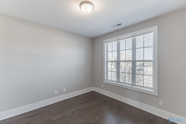 unfurnished room featuring dark hardwood / wood-style flooring