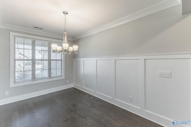 unfurnished dining area with dark hardwood / wood-style flooring, a chandelier, and ornamental molding