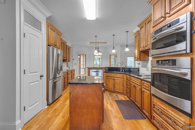 89 Lyle Cir, Somerville, AL 35670 - kitchen with appliances with stainless steel finishes, a peninsula, brown cabinets, a center island, and ornamental molding