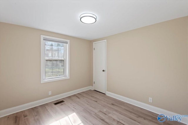 unfurnished room with light wood-type flooring