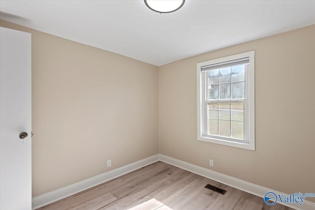 spare room featuring light hardwood / wood-style floors