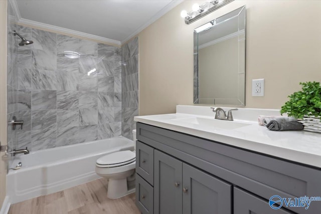 full bathroom with toilet, ornamental molding, tiled shower / bath combo, and hardwood / wood-style flooring