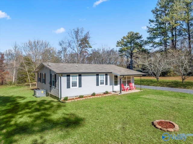 ranch-style house with a front lawn, central AC unit, and a patio area