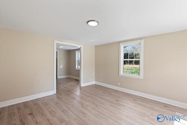 spare room featuring light wood-type flooring