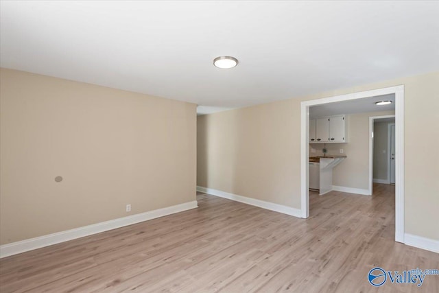 spare room featuring light wood-type flooring