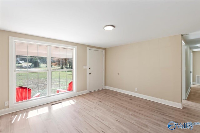 spare room featuring light wood-type flooring