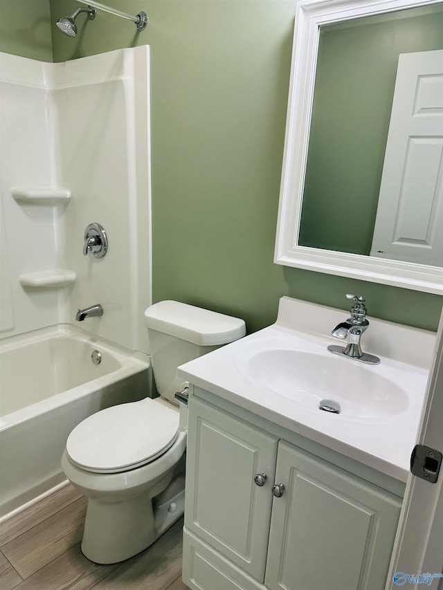 full bathroom featuring vanity, wood-type flooring, shower / bathtub combination, and toilet