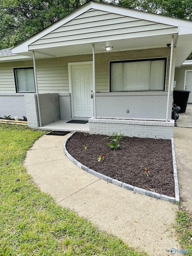 doorway to property featuring covered porch