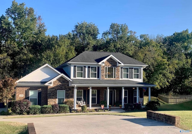 view of front of house featuring a porch and a front lawn