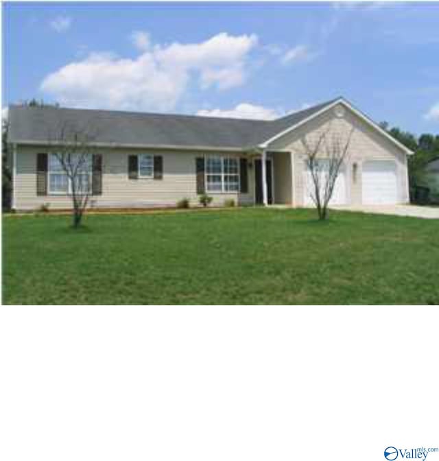 ranch-style house with a garage and a front lawn