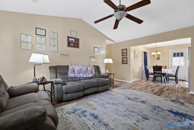 living room with hardwood / wood-style floors, ceiling fan with notable chandelier, and lofted ceiling