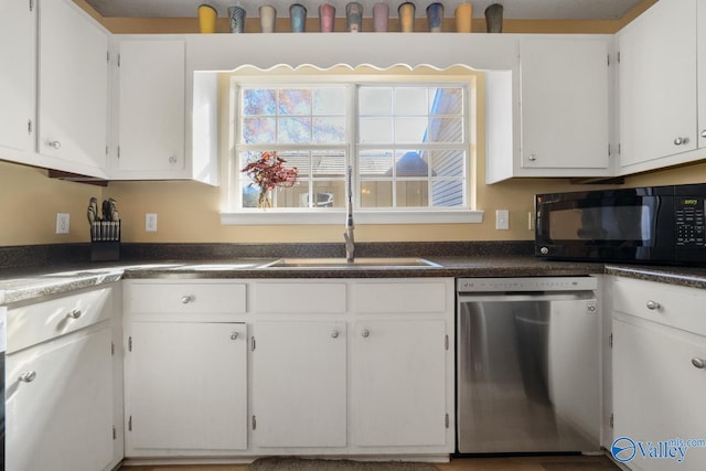 kitchen with a textured ceiling, dishwasher, white cabinetry, and sink