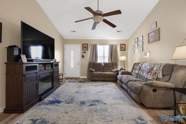 living room featuring high vaulted ceiling, light hardwood / wood-style flooring, and ceiling fan