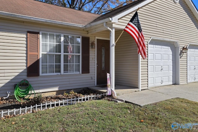 view of front of property with a front yard and a garage