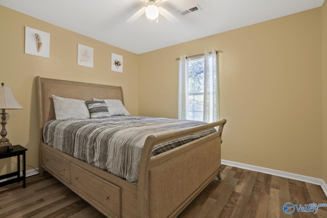 bedroom with ceiling fan and dark wood-type flooring