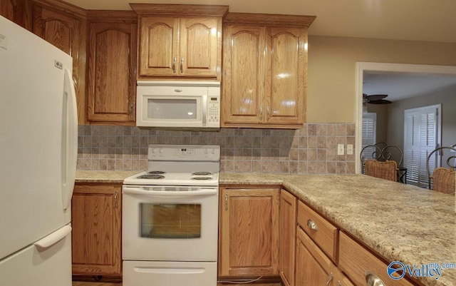 2220 Jefferson St, Courtland, AL 35618 - kitchen with white appliances, tasteful backsplash, and brown cabinets